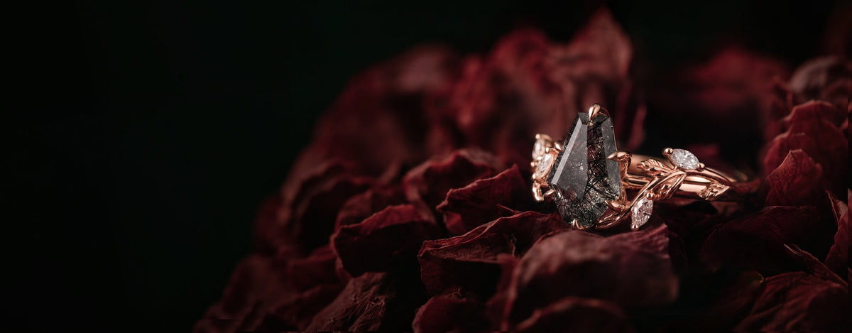 Noirva red marquise gemstone ring on dark textured wood